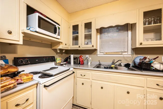 a kitchen with stainless steel appliances granite countertop a stove and a sink