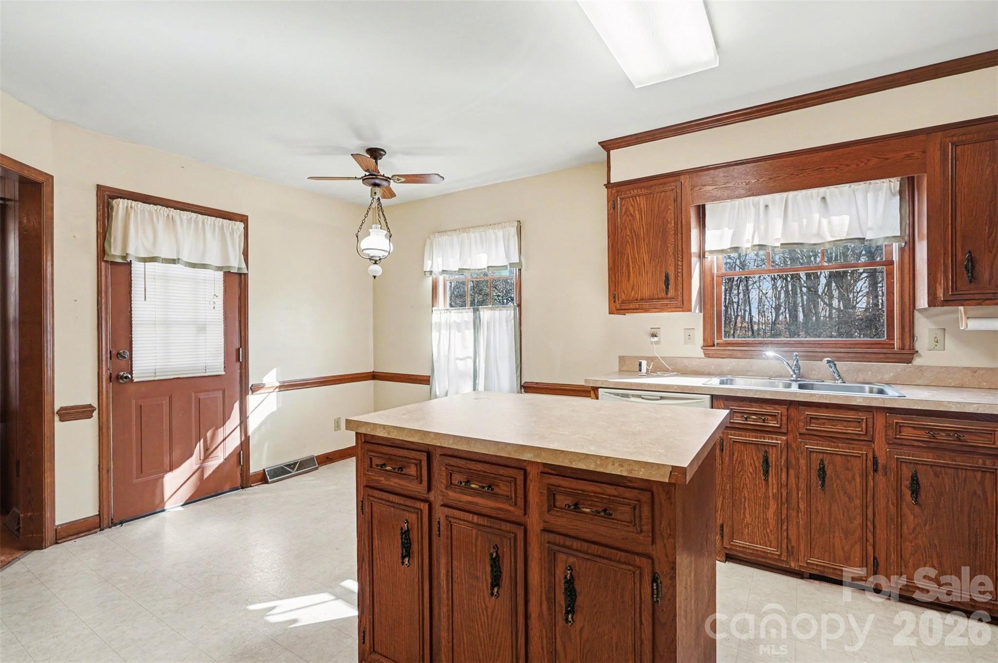 2116 Rice Road Matthews, NC 28105 - Photo 6 of 15 a kitchen with a sink a window and cabinets