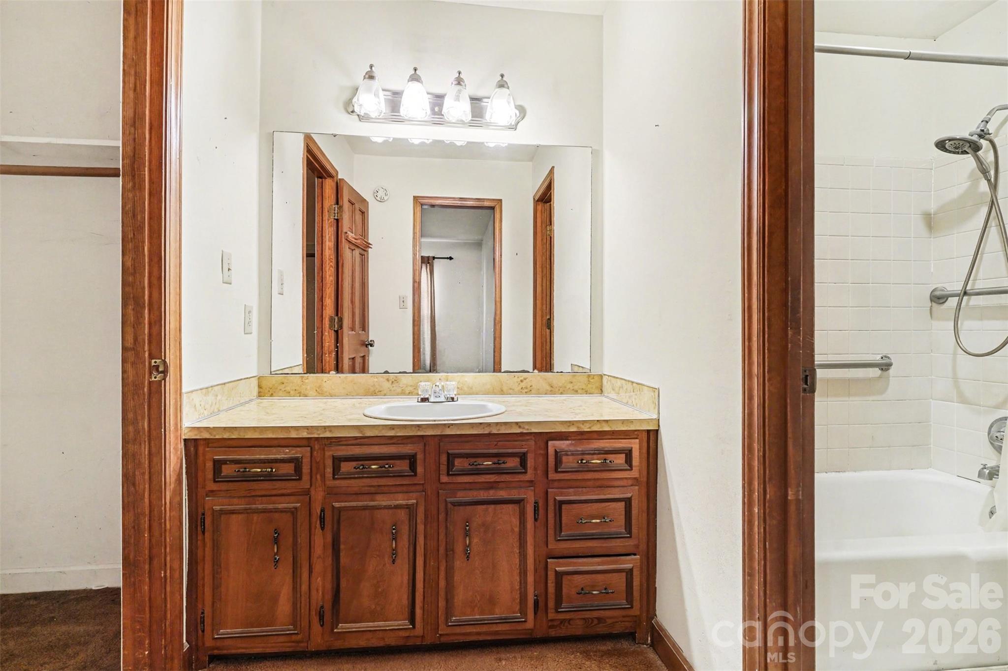 2116 Rice Road Matthews, NC 28105 - Photo 8 of 15 a bathroom with a granite countertop sink a mirror and a vanity