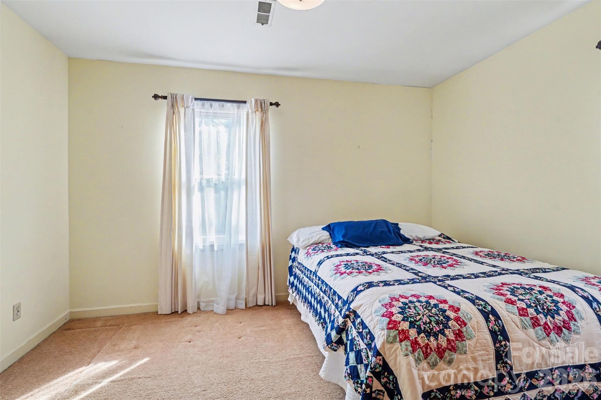 2116 Rice Road Matthews, NC 28105 - Photo 10 of 15 a bedroom with a bed and a window