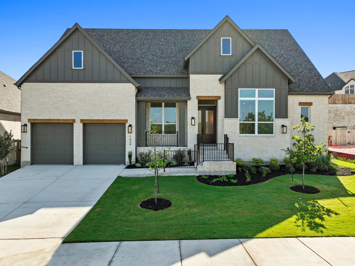 1424 Jolie Rose Bend Leander, TX 78641 - Photo 1 of 1 View of front of property featuring board and batten siding, concrete driveway, an attached garage, and a front lawn