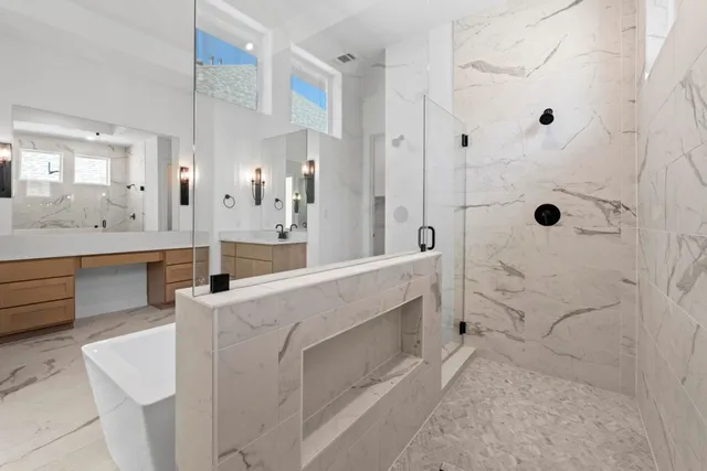 a white bath tub sitting next to a bathroom sink