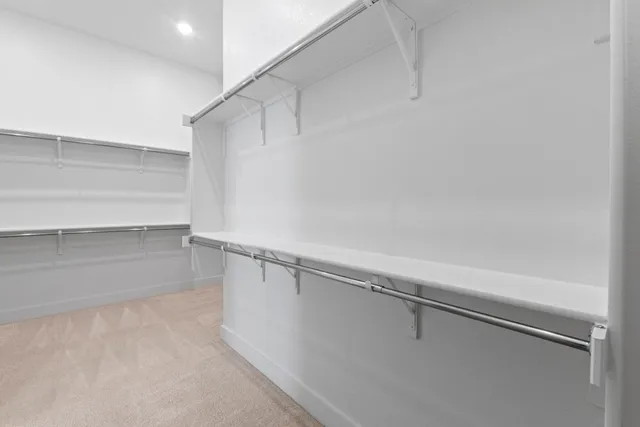 a large white bathroom with a granite countertop sink mirror and shower