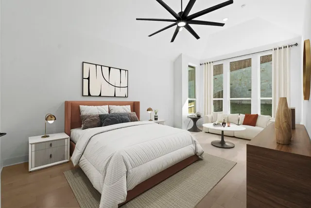 a bedroom with a bed and large window