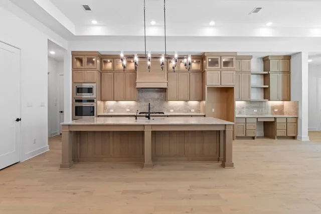 a kitchen with counter top space cabinets and appliances