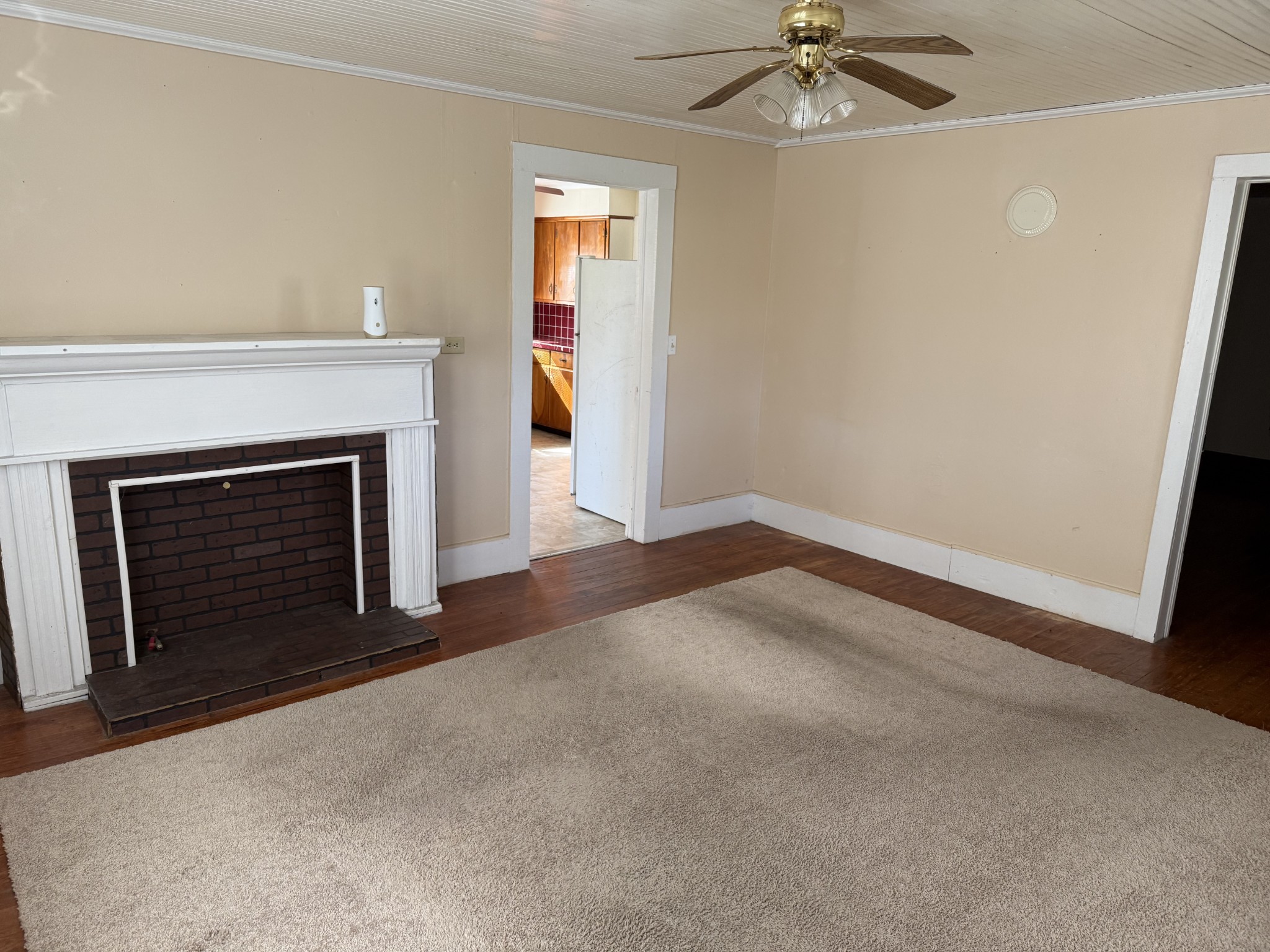 21625 Seminary Street Hollow Rock, TN 38342 - Photo 9 of 17 an empty room with a fireplace and fan