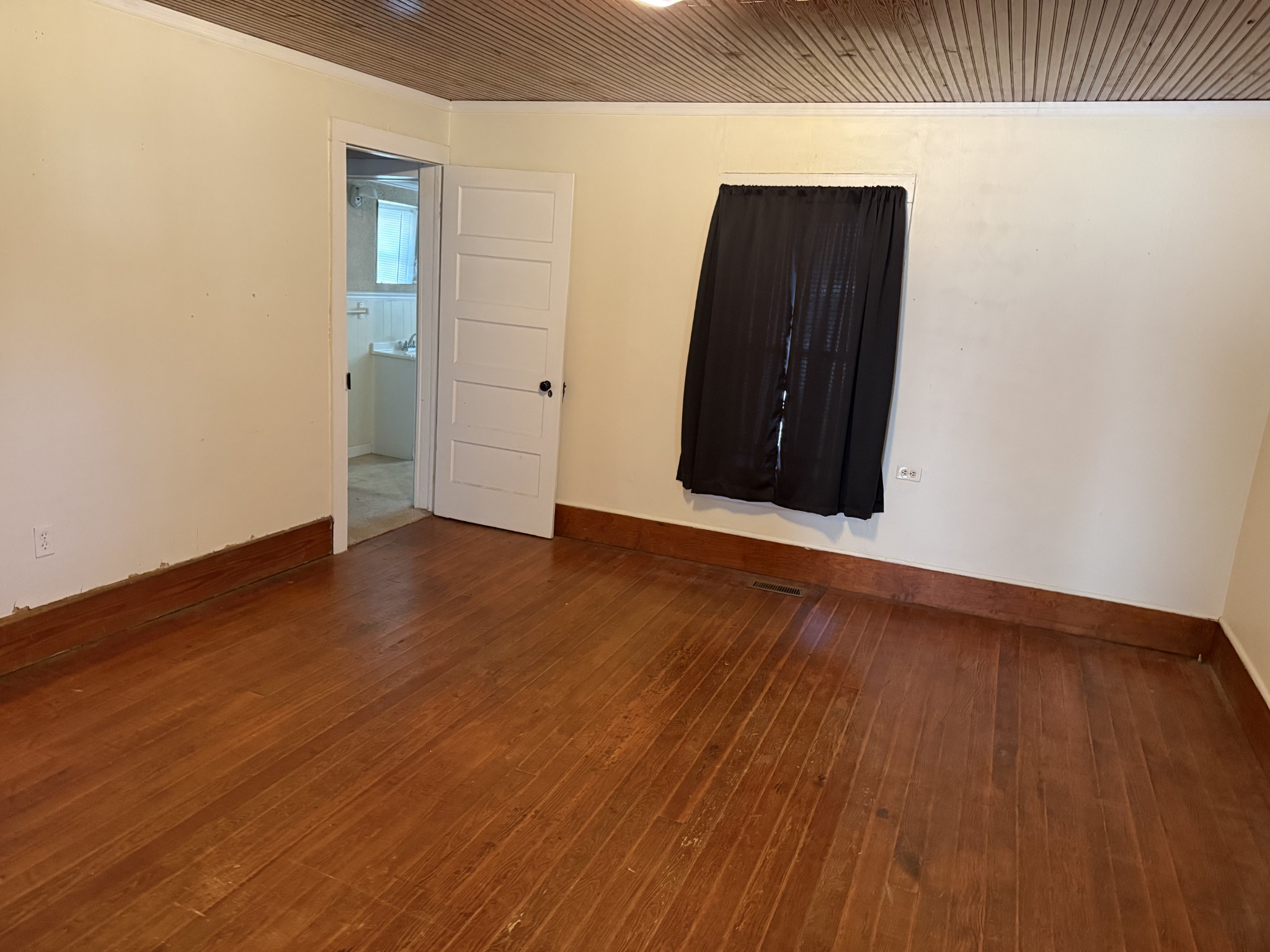21625 Seminary Street Hollow Rock, TN 38342 - Photo 10 of 17 an empty room with wooden floor and windows