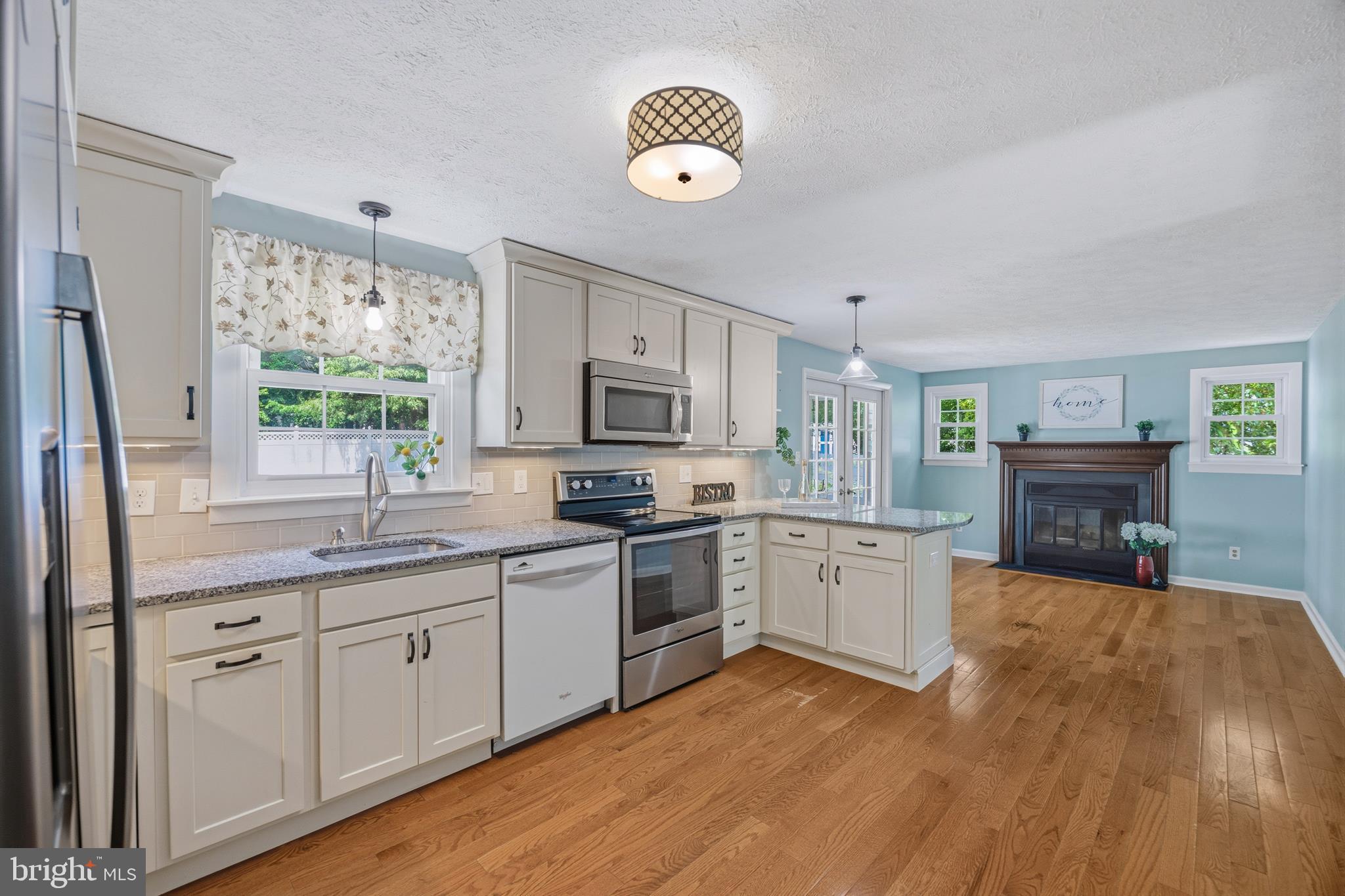 1506 Gollum Road Hanover, MD 21076 - Photo 12 of 44 a kitchen with a sink dishwasher a dining table and chairs with wooden floor