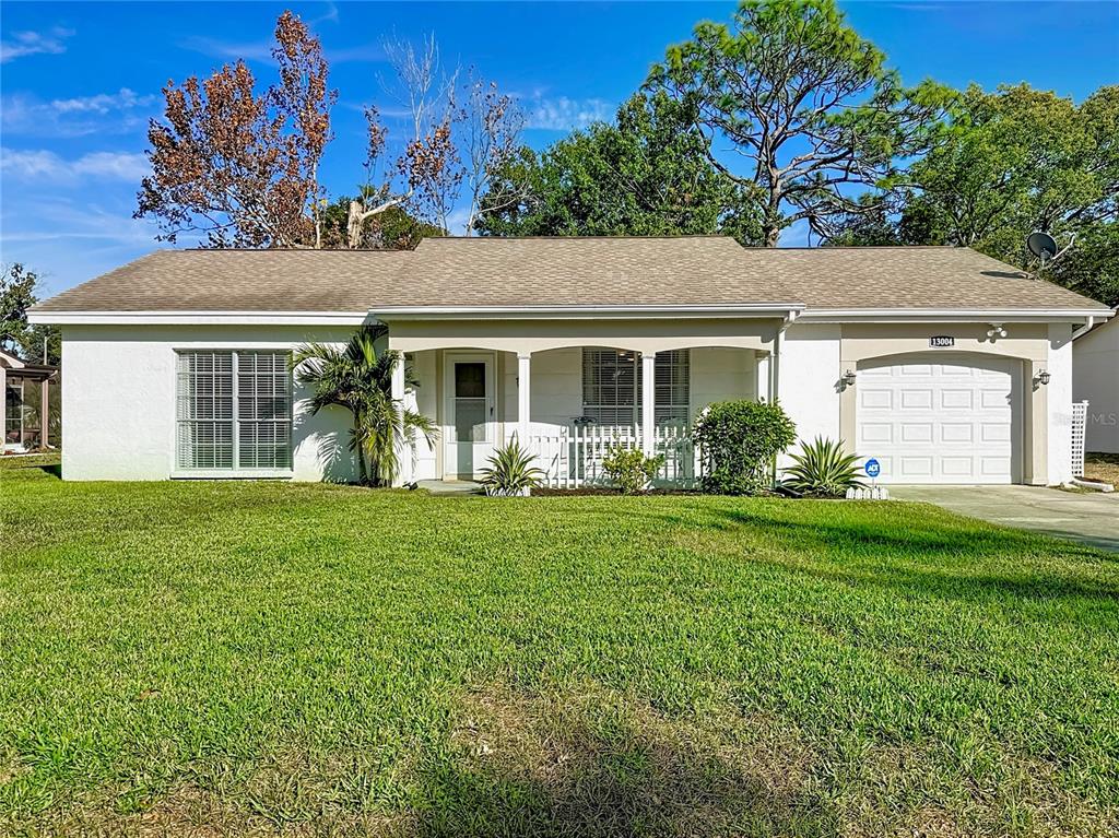 a front view of house with yard and green space