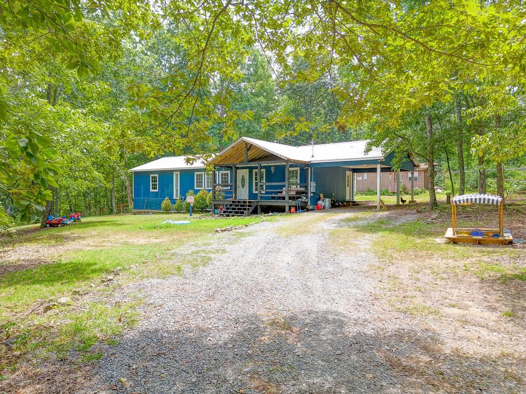 a front view of a house with a yard table and chairs