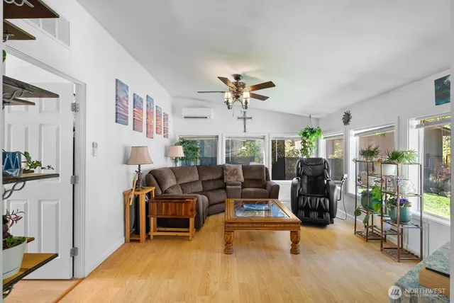 a living room with furniture and a wooden floor