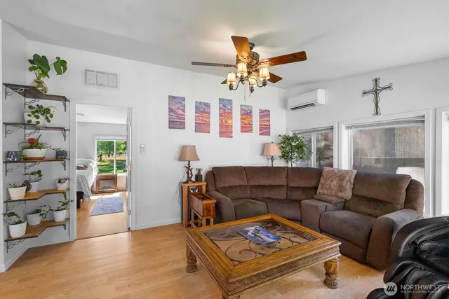 a living room with furniture and wooden floor