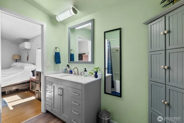 a bathroom with a double vanity sink mirror and toilet