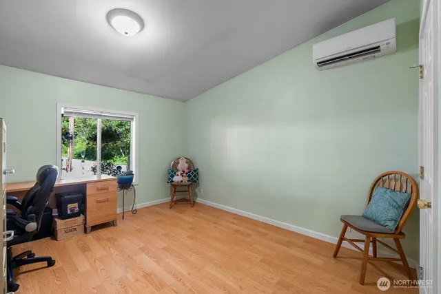 a view of a workspace with furniture and a window