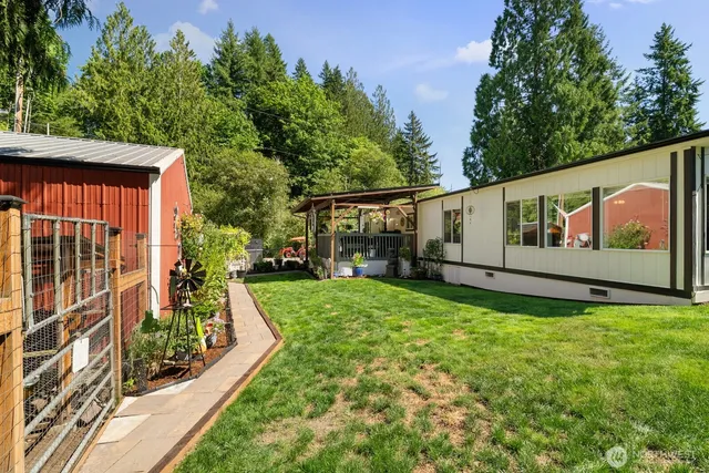 a view of backyard with garden and deck