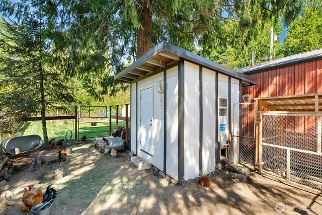 a backyard of a house with barbeque oven table and chairs