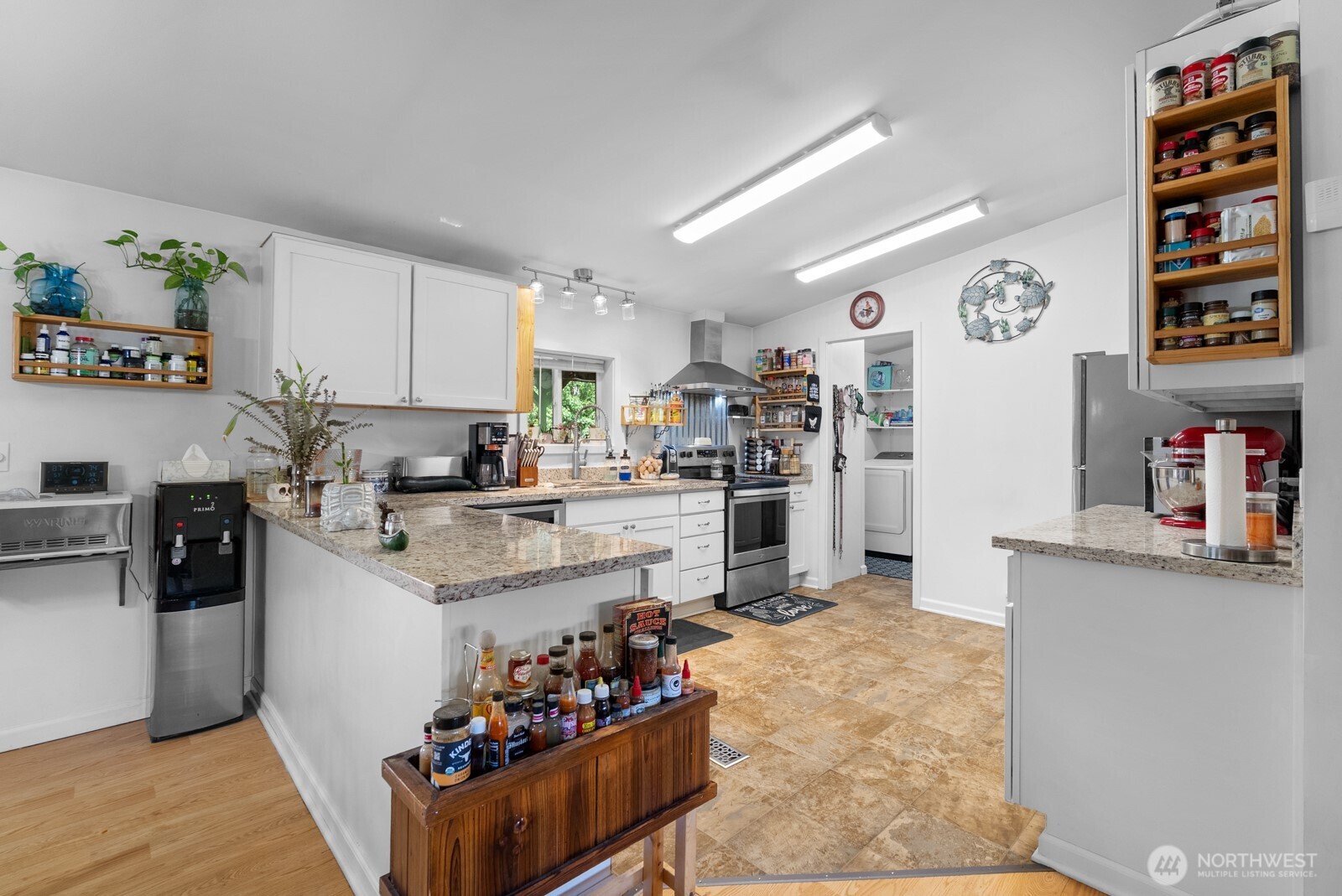 12933 Trout Farm Road Sultan, WA 98294 - Photo 8 of 38 a kitchen with stainless steel appliances kitchen island granite countertop a refrigerator and a stove top oven