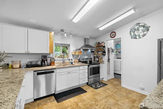 a kitchen with a sink cabinets and window