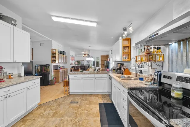 a kitchen with a sink stove and cabinets