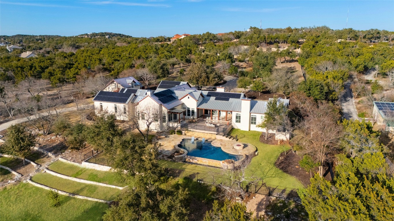 an aerial view of a house with a yard