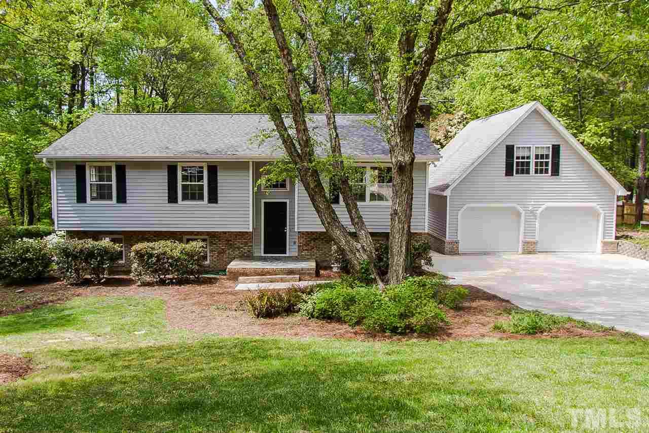 7617 Elliot Drive Raleigh, NC 27613 - Photo 1 of 25 a front view of a house with a yard and garage
