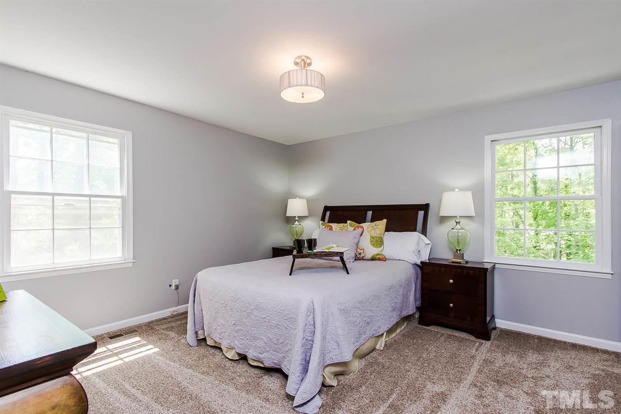7617 Elliot Drive Raleigh, NC 27613 - Photo 11 of 25 a bedroom with a bed and a window