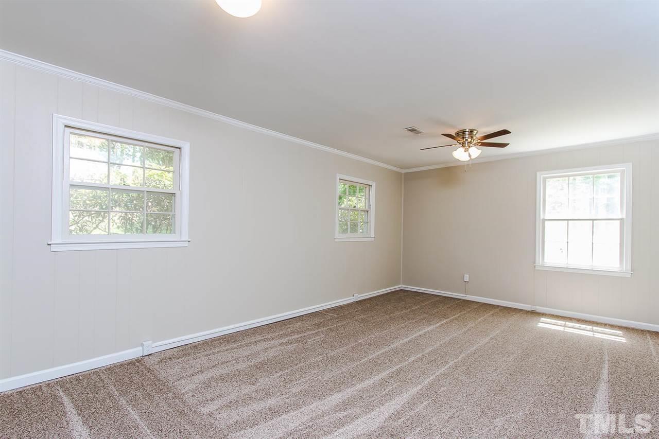7617 Elliot Drive Raleigh, NC 27613 - Photo 13 of 25 wooden floor in an empty room with a window