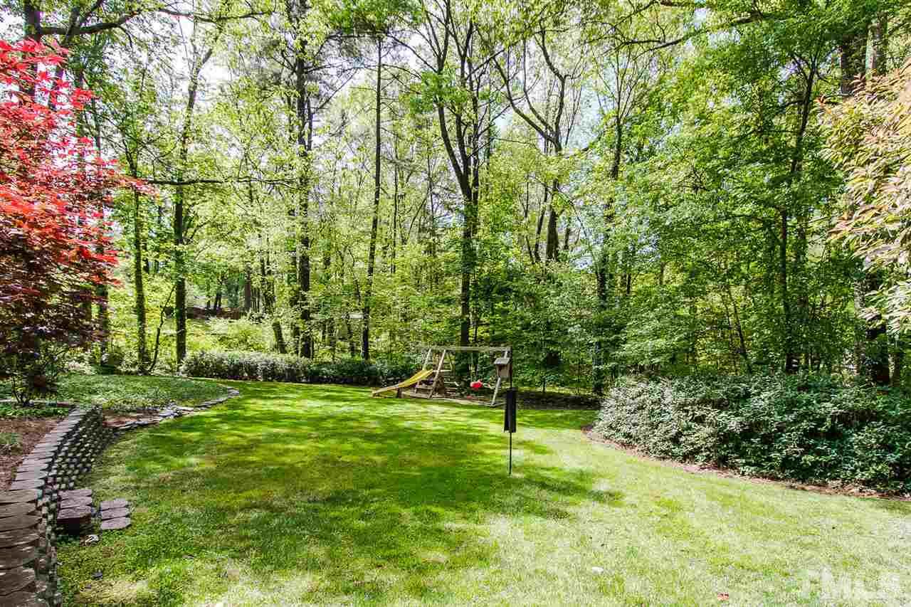 7617 Elliot Drive Raleigh, NC 27613 - Photo 24 of 25 a backyard of a house with lots of green space