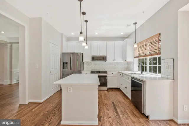 a kitchen with a sink stove and refrigerator