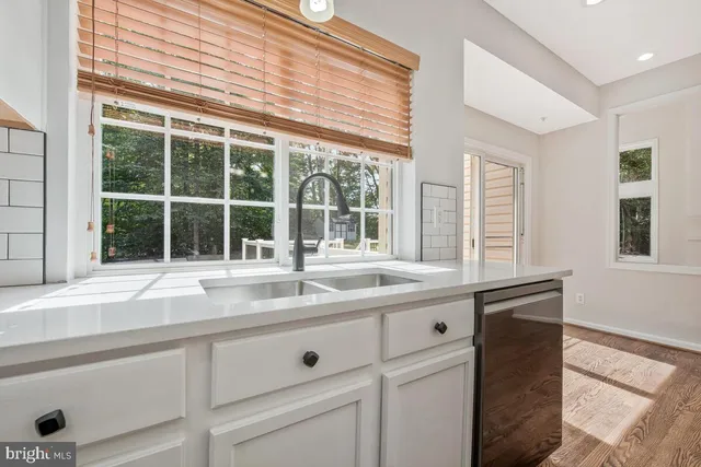 a spacious bathroom with a double vanity sink a mirror and shower