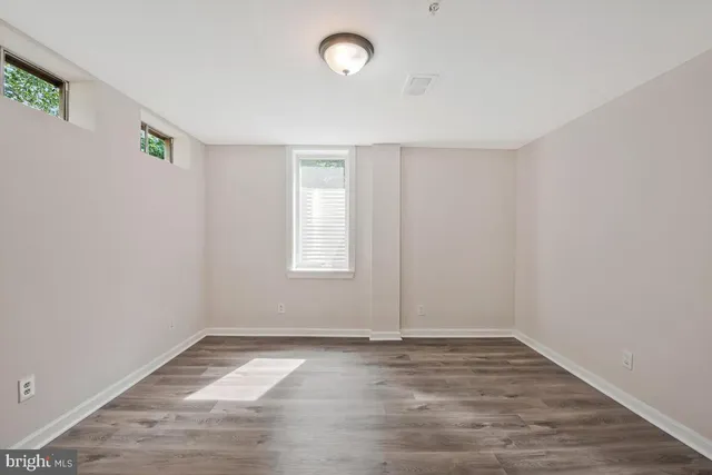 a bathroom with a granite countertop sink a toilet and mirror