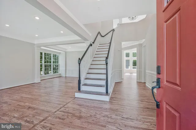 a view of entryway with wooden floor and stairs