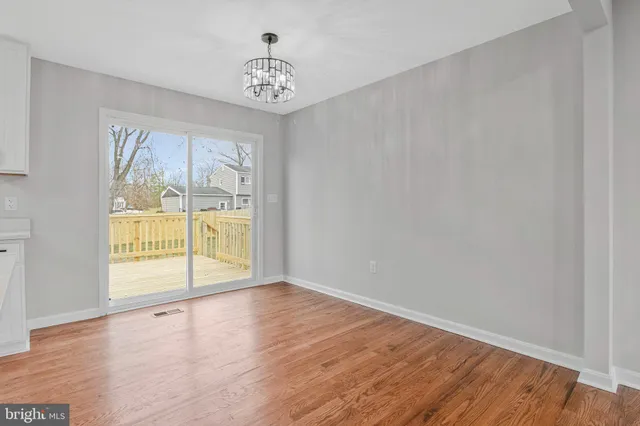 a view of kitchen with sink and wooden floor