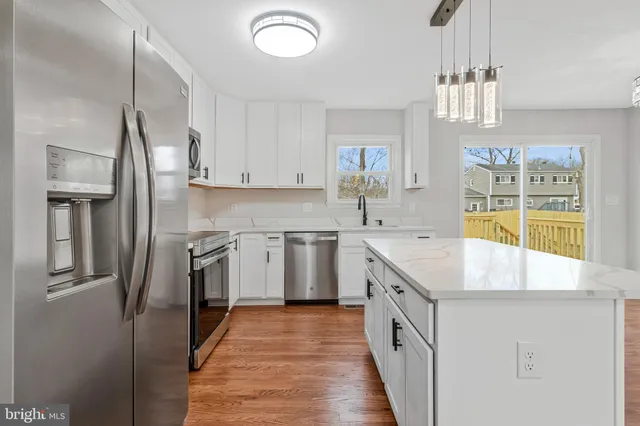 a kitchen with a counter space a sink and appliances