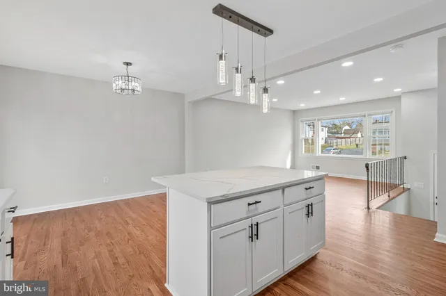 a kitchen with stainless steel appliances granite countertop a sink stove and microwave