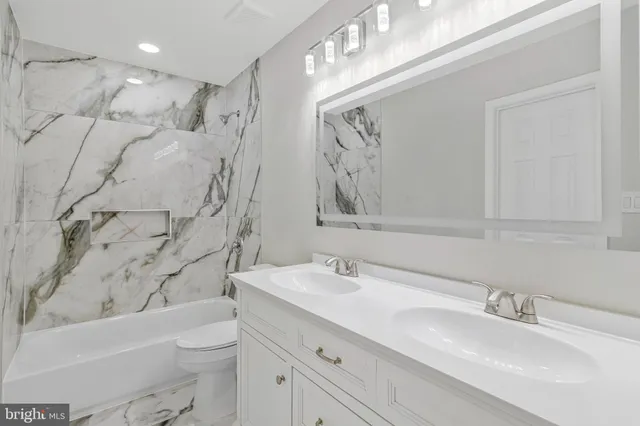 a bathroom with a sink double vanity and tub