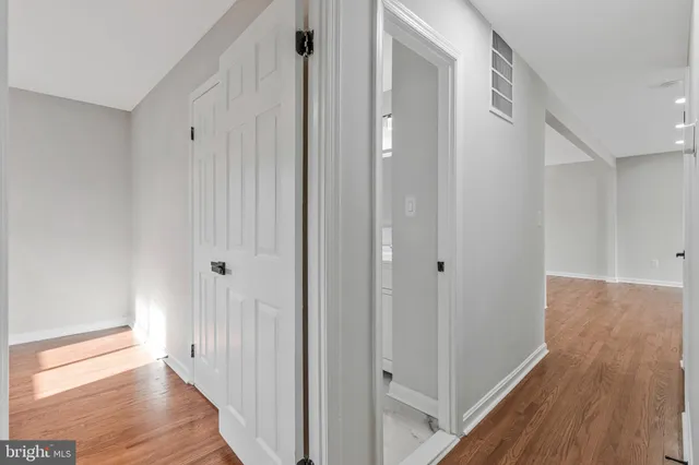 a view of a room with wooden floor and window