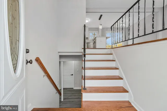 a view of staircase with wooden floor and a window