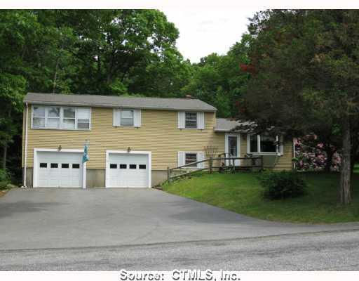 Exterior Front. Attractive Split level ranch with two car garage shows new roof, garage doors, front door and driveway!
