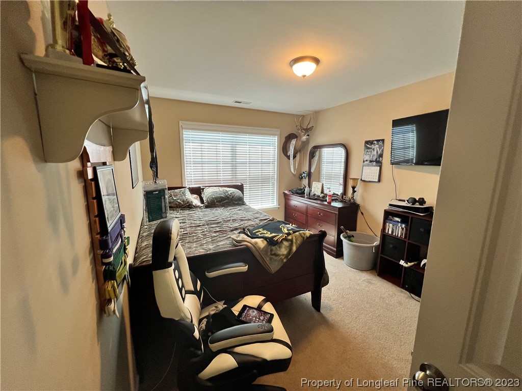 73 Blue Bay Lane Cameron, NC 28326 - Photo 28 of 42 a bed room with furniture and a window