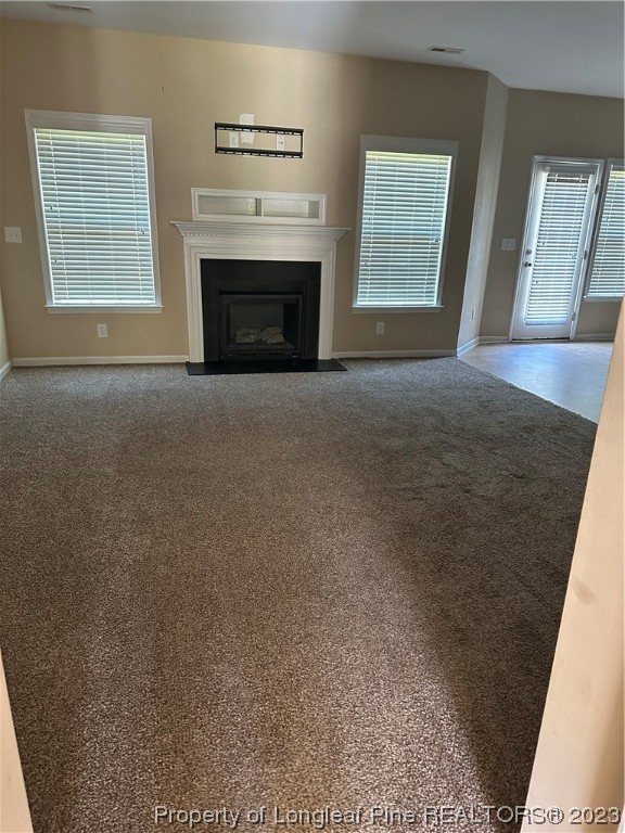 73 Blue Bay Lane Cameron, NC 28326 - Photo 6 of 42 a view of an empty room with a fireplace and a window