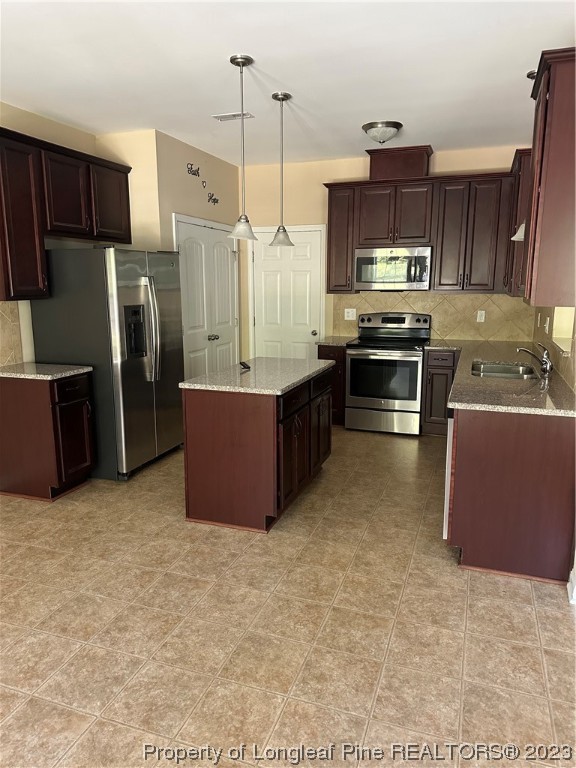 73 Blue Bay Lane Cameron, NC 28326 - Photo 9 of 42 a kitchen with stainless steel appliances a stove a refrigerator a sink a oven with wooden cabinets