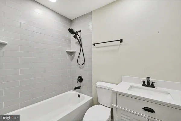 a large white kitchen with kitchen island a sink wooden floor and a stove