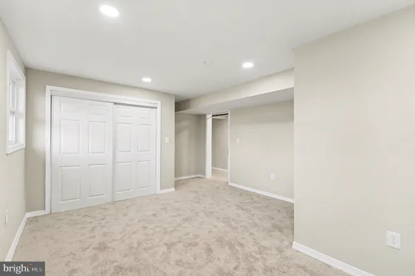 an empty room with wooden floor and a window