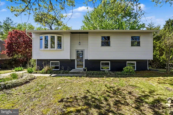 a backyard of a house with yard and outdoor seating
