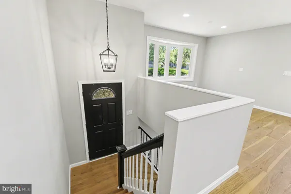 a view of entryway with a window and wooden floor