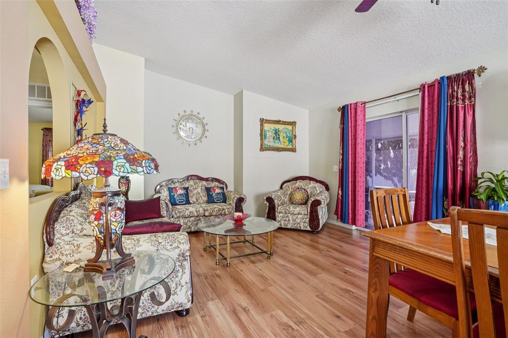 2315 Belfry Way Mascotte, FL 34753 - Photo 11 of 55 a living room with furniture a piano and a flat screen tv