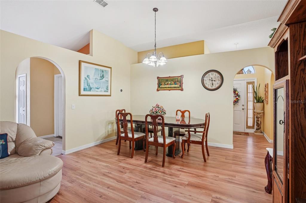 2315 Belfry Way Mascotte, FL 34753 - Photo 14 of 55 a view of a dining room with furniture and wooden floor