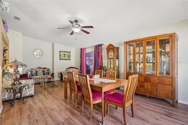 a living room with furniture and kitchen view