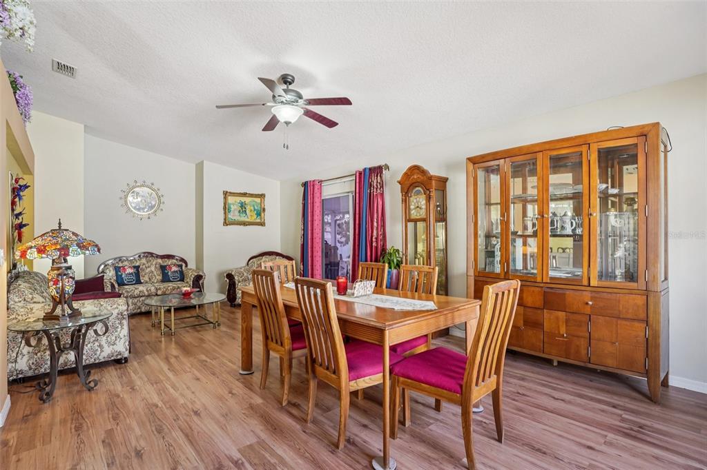 2315 Belfry Way Mascotte, FL 34753 - Photo 16 of 55 a view of a dining room with furniture window and wooden floor